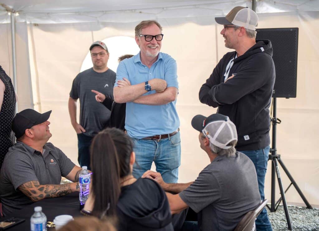 Celebrating the Argonaut Gold acquistion at Magino Mine: Left John McCluskey, Alamos CEO; right Greg Fisher, CFO